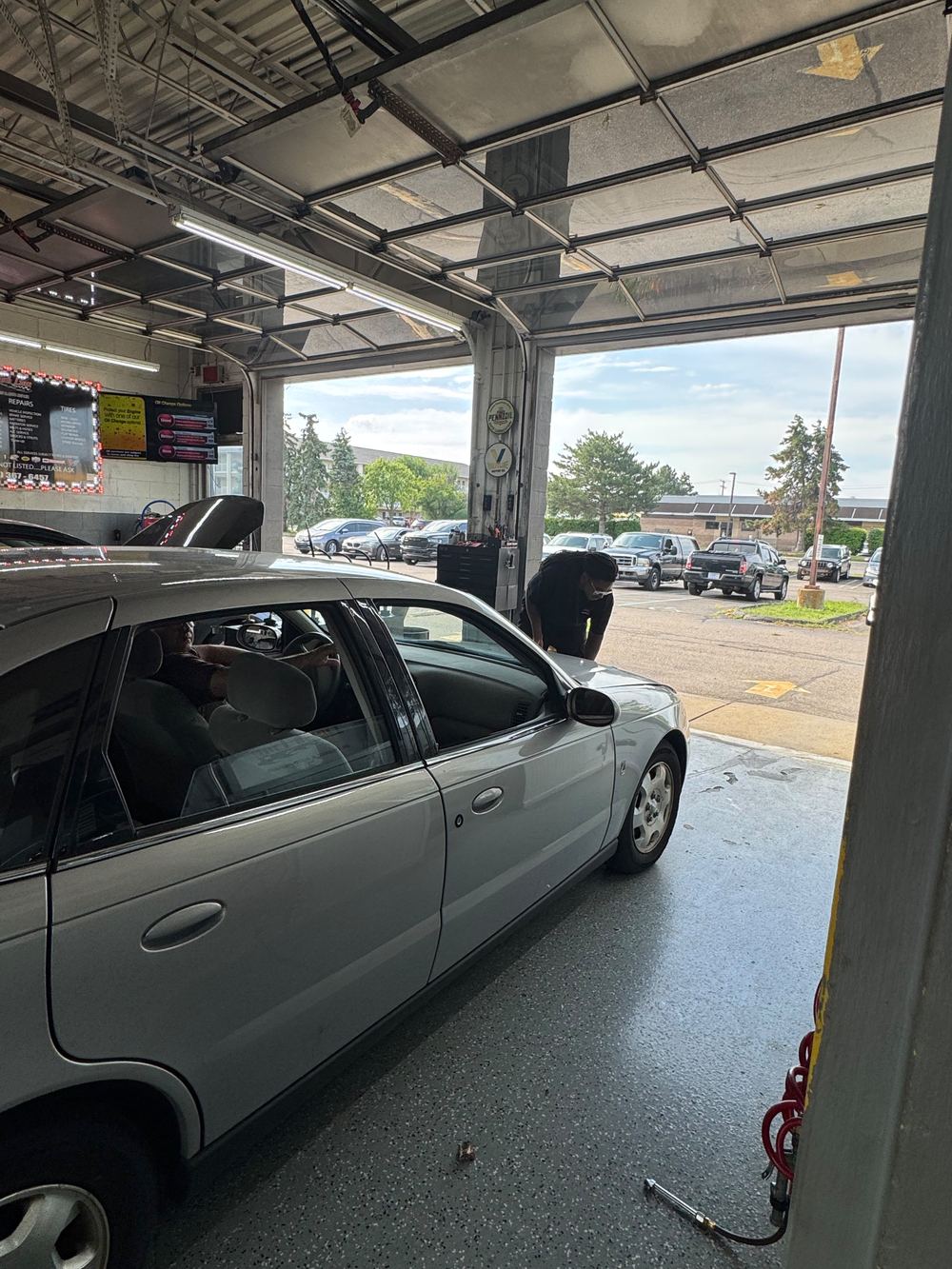 Inside a Finish Line service bay with a vehicle up on the lift