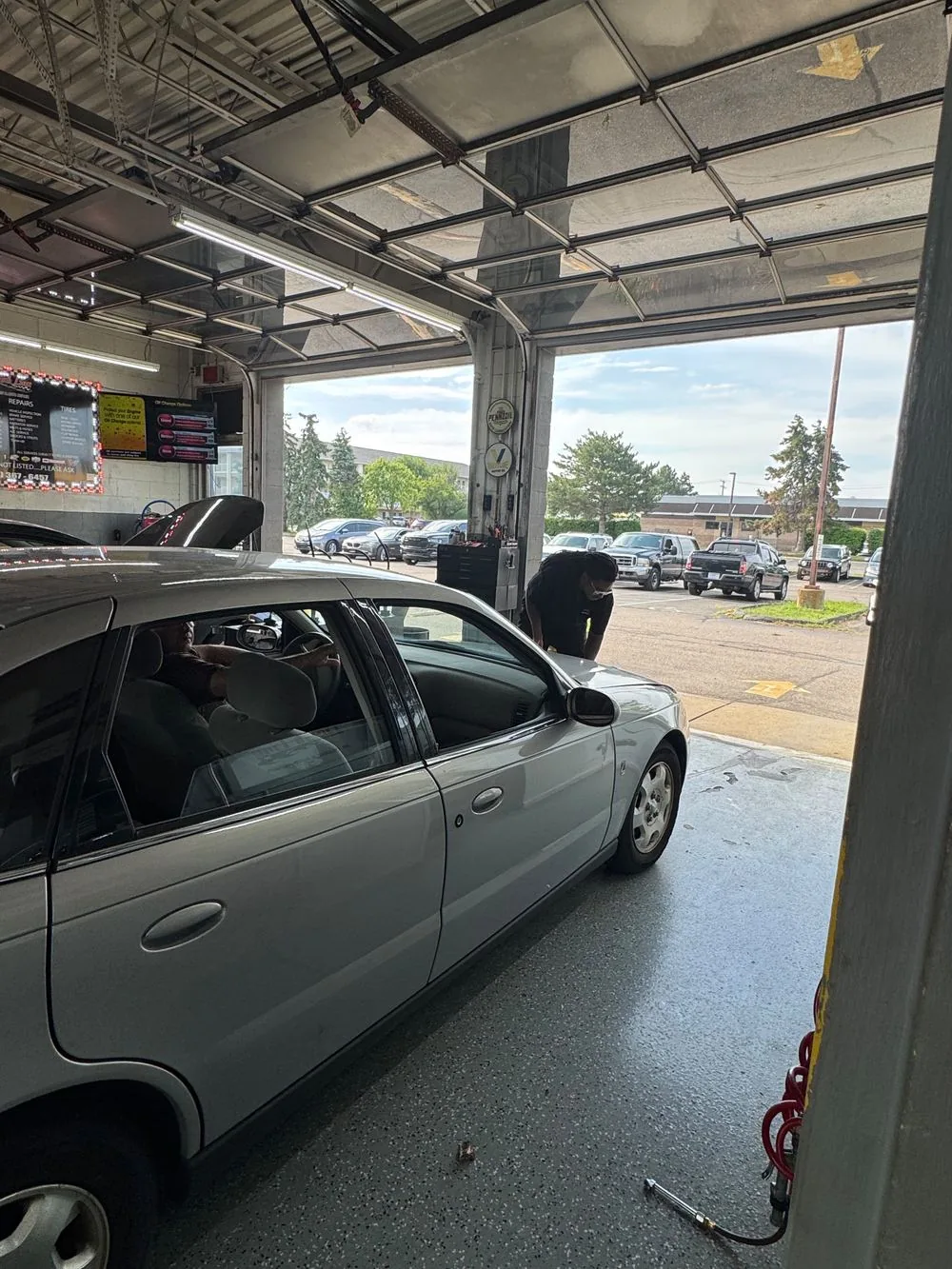 Inside a Finish Line service bay with a vehicle up on the lift