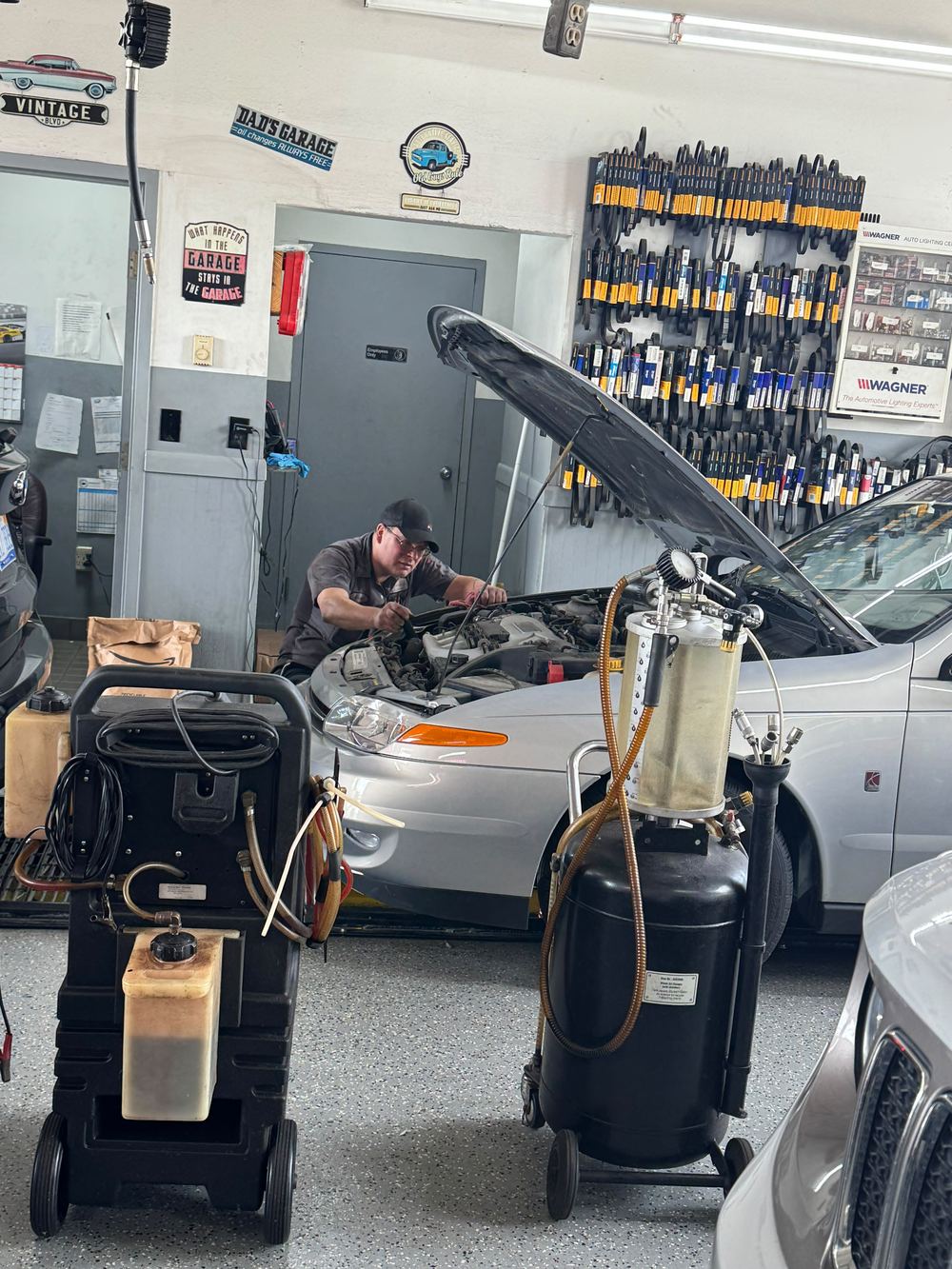 Finish Line technician diagnosing and repairing a vehicle engine in Livonia, MI